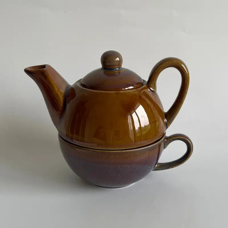 Brown ceramic One cup kettle yellow set on a light gray background