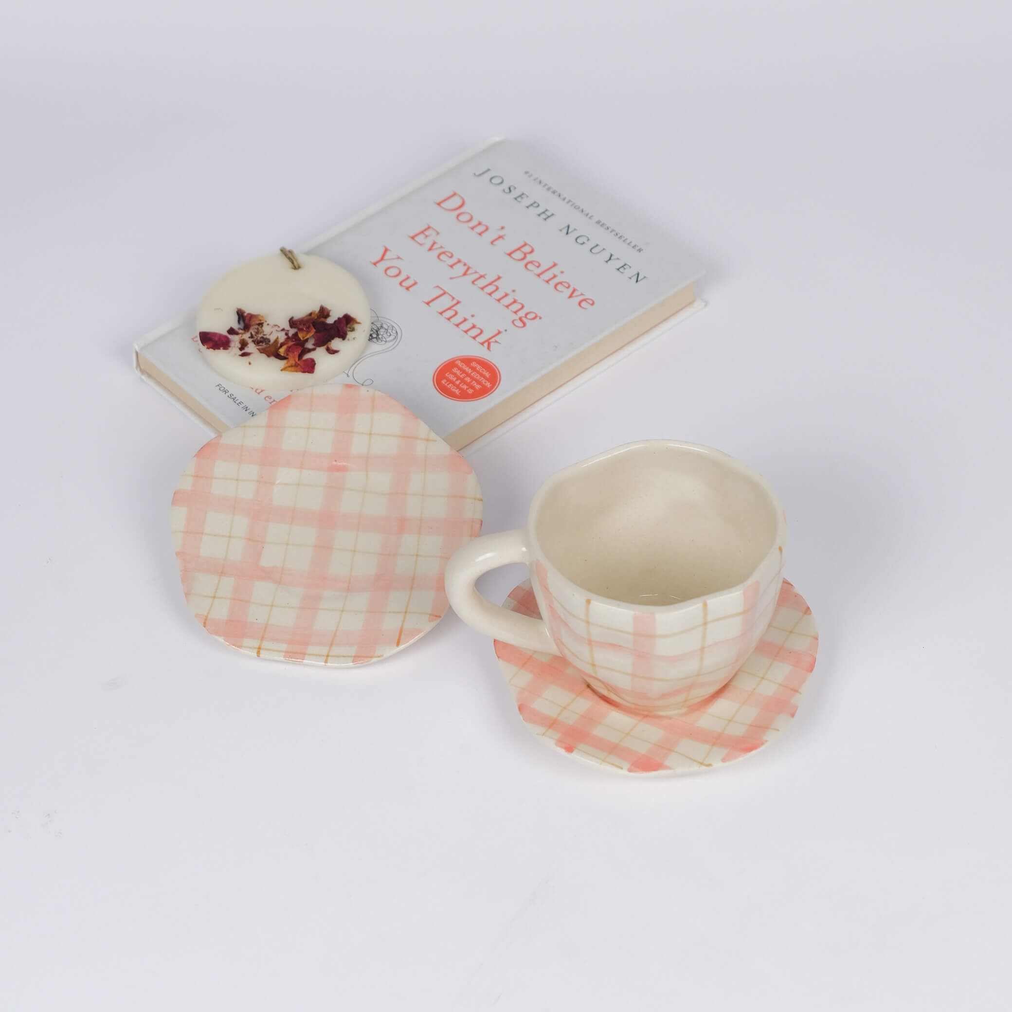 Pink checkered ceramic cup and saucer